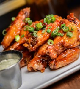 Close up Photo of Traditional Wings and Ranch Dressing.