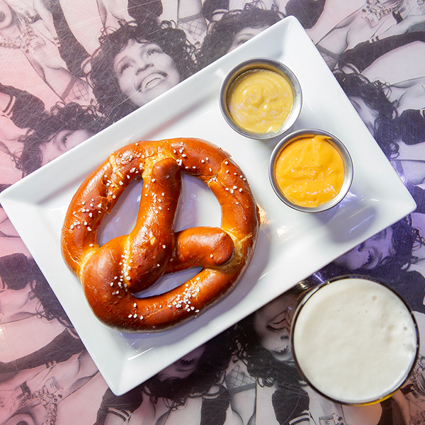 Close Up Photo of Twisted Pretzel and Dip